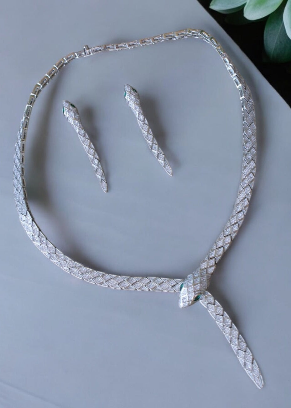 Serpentine diamond necklace set with emerald eyes and matching serpent earrings